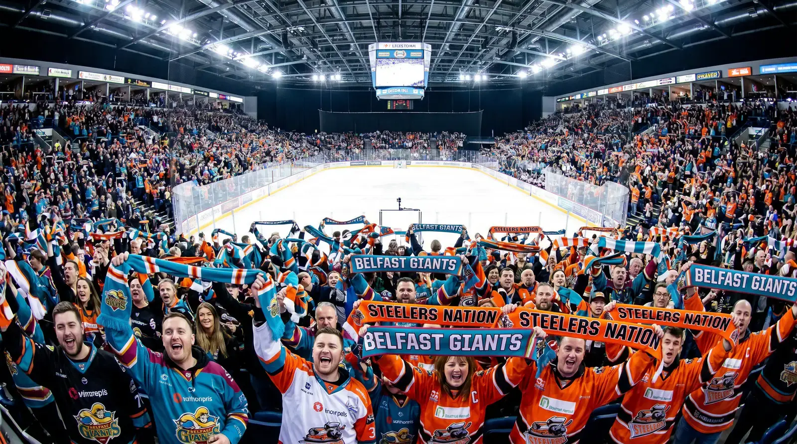 Enthusiastic EIHL crowd waving team scarves in a sold-out arena