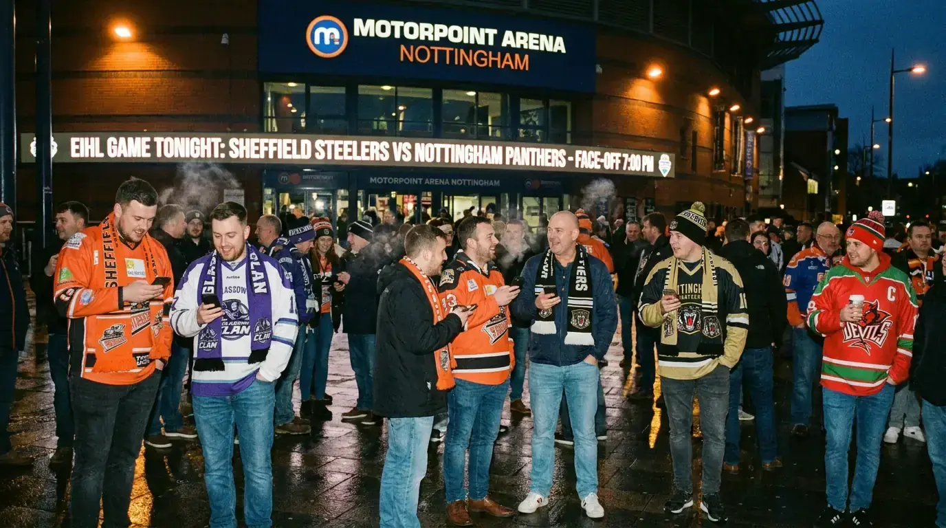 EIHL fans discussing team news on mobile phones outside a British ice hockey arena before a game