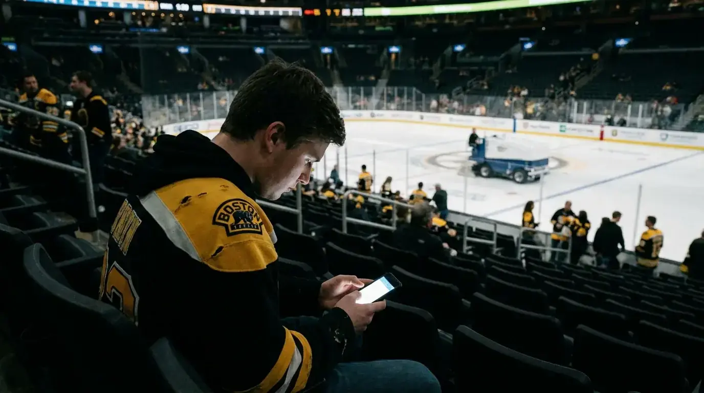 Fan checking live betting odds on a phone during an intermission break