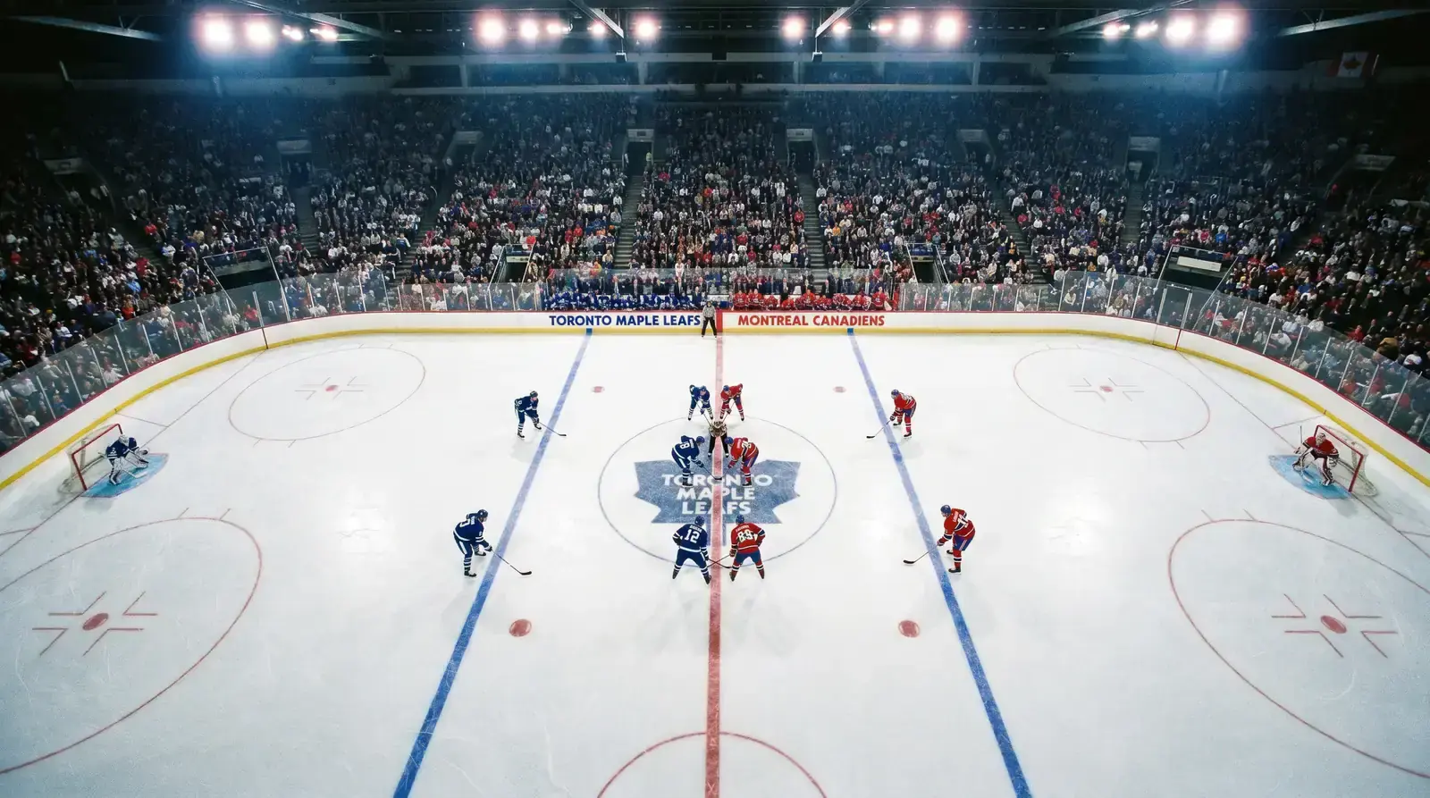 Two hockey teams facing off with a clear view of defensive positioning