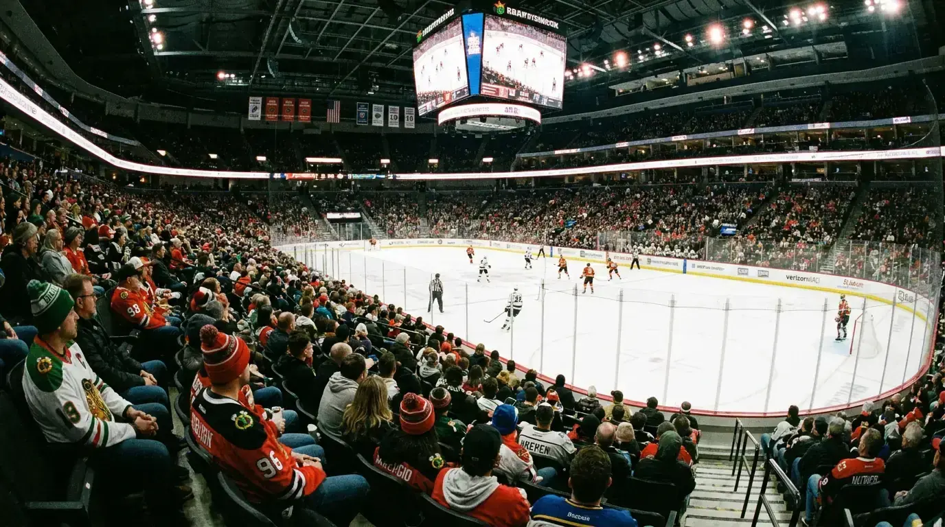Hockey fans watching a regular season NHL game from the upper deck of a packed arena