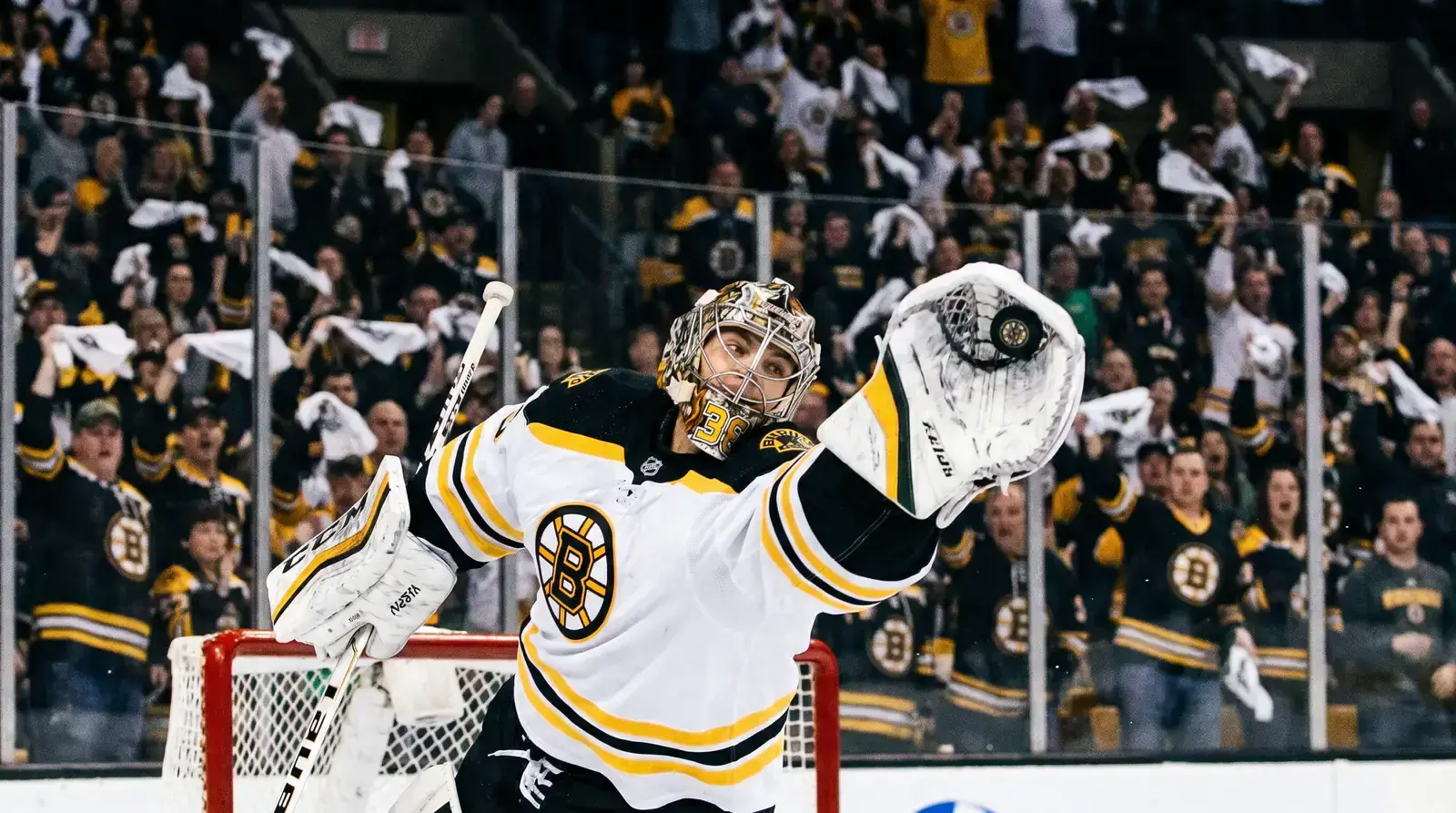 NHL playoff goaltender making a key save during an intense postseason game