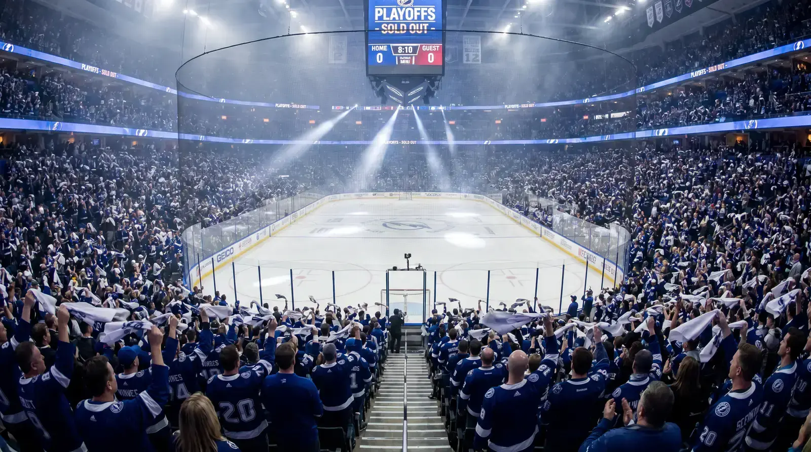 Split view of a regular season NHL arena and a packed playoff atmosphere showing intensity difference