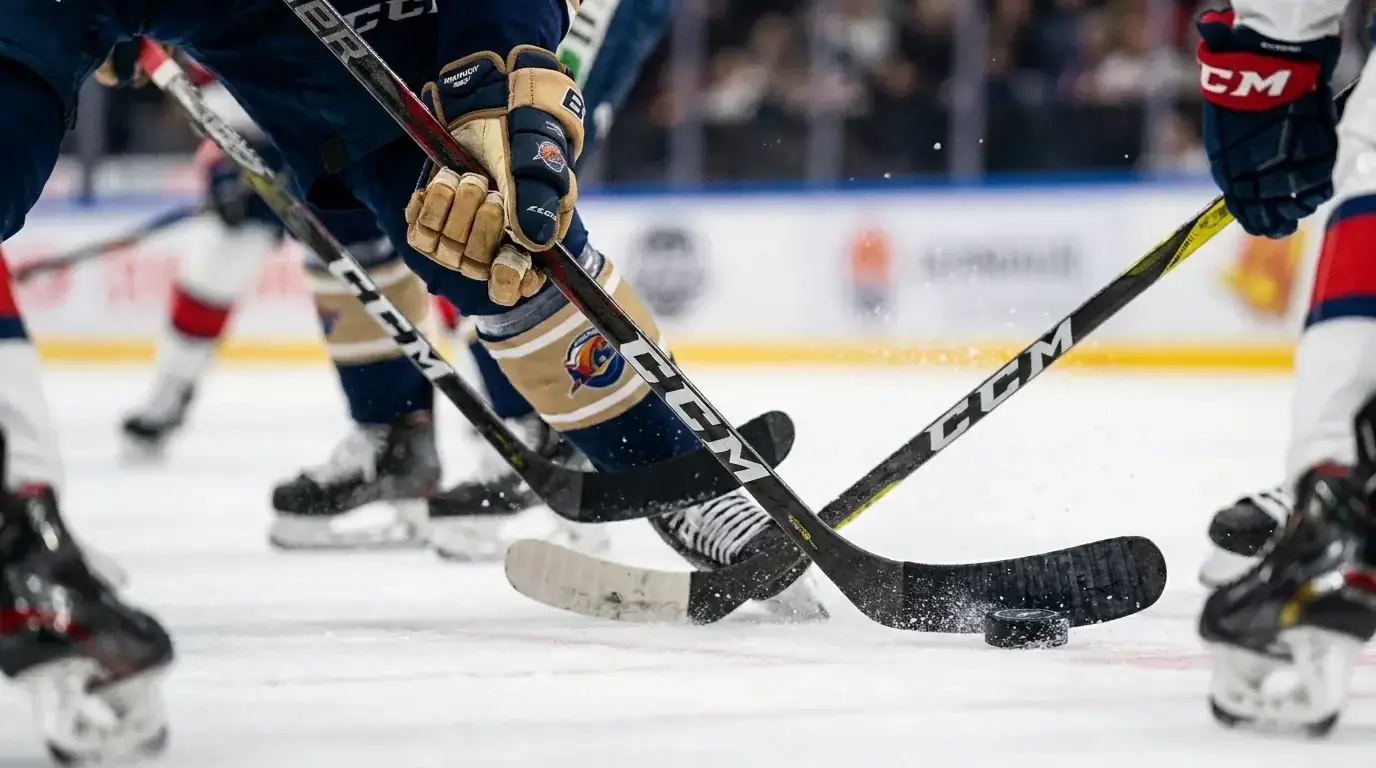 Close-up of an ice hockey forward stick-handling the puck past a defender