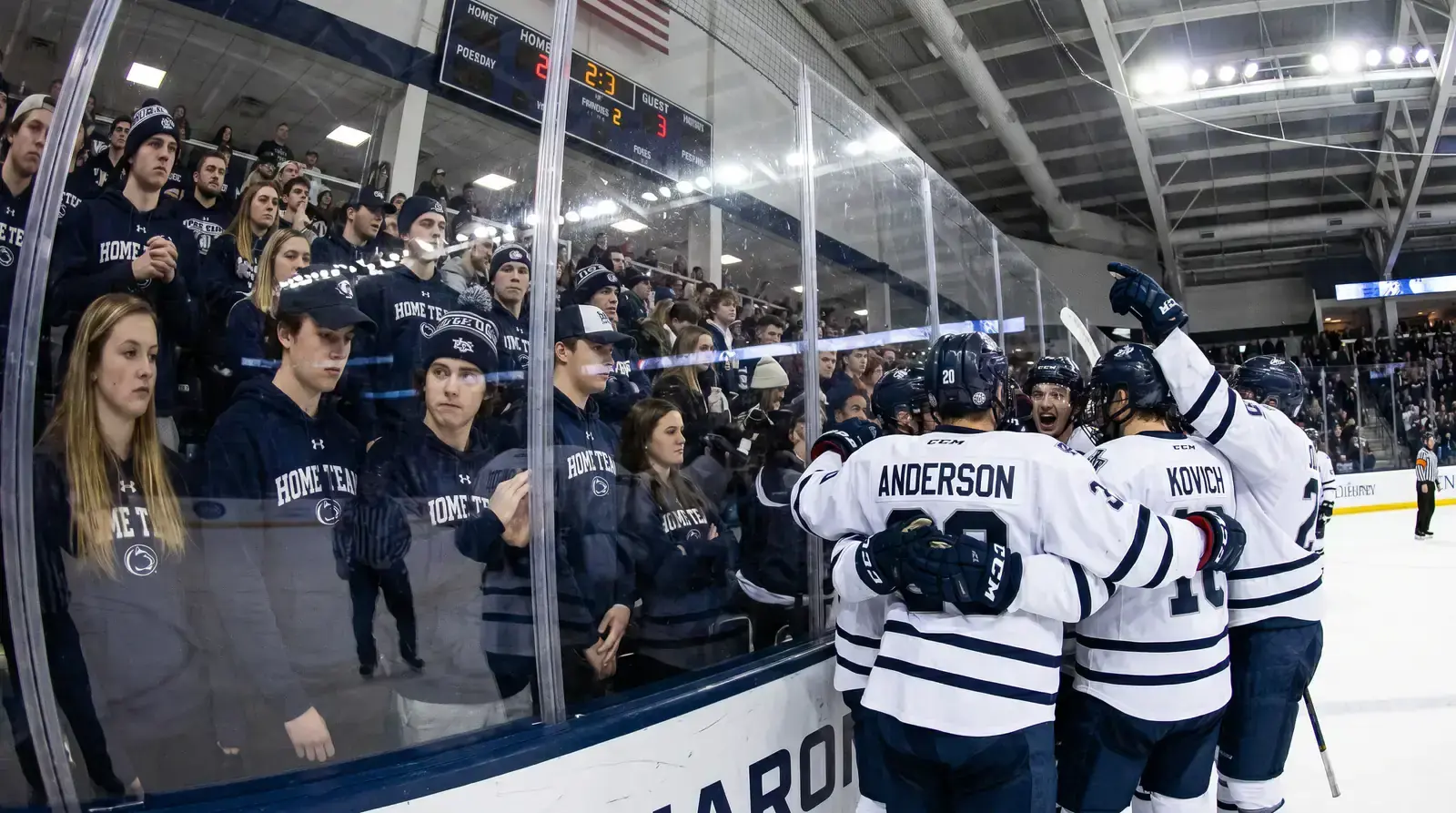 Hockey players celebrating an upset goal on the road in a hostile arena