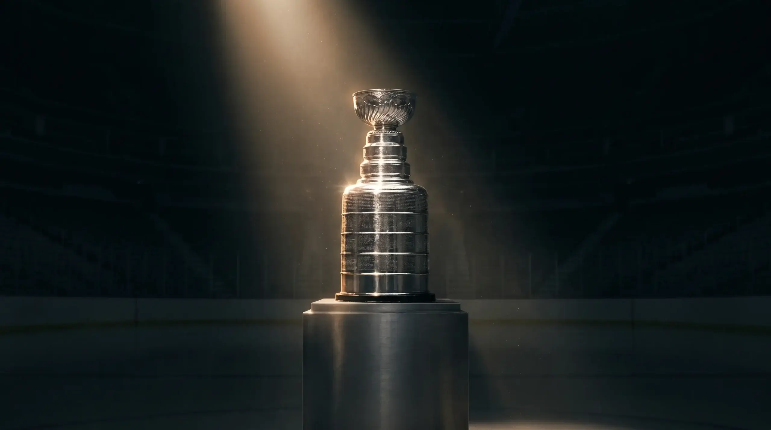 Stanley Cup trophy gleaming under spotlight in a darkened arena